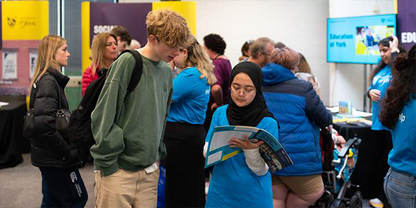 Student Ambassador showing a student the Open Day programme